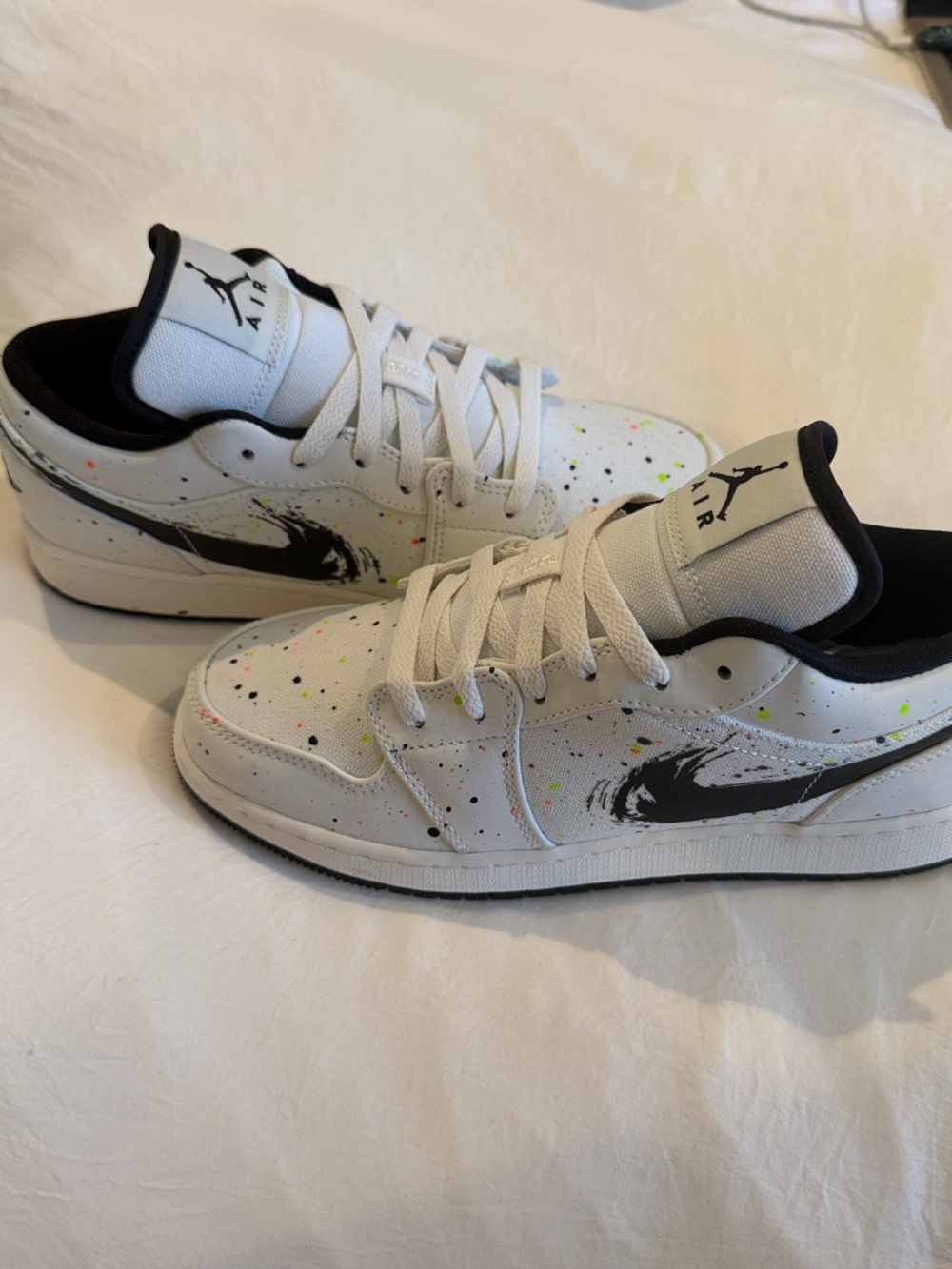 Jordan White Low-Top Sneakers with Black Swoosh and Neon Splatter